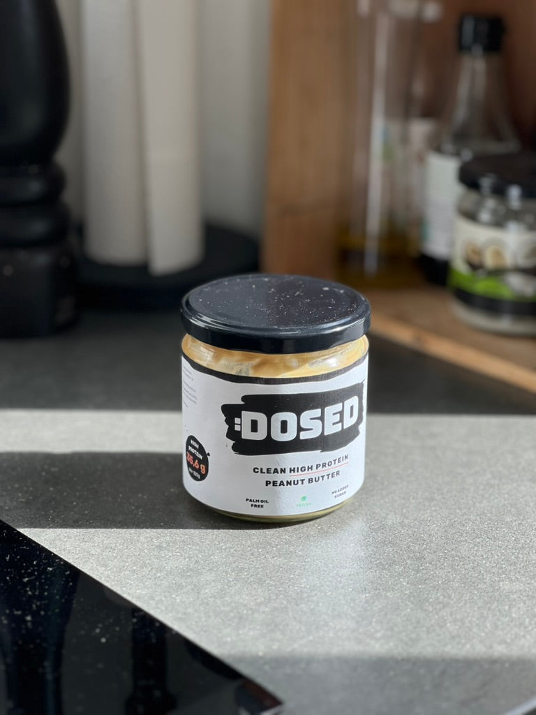 Jar of Dosed peanut butter on a kitchen counter